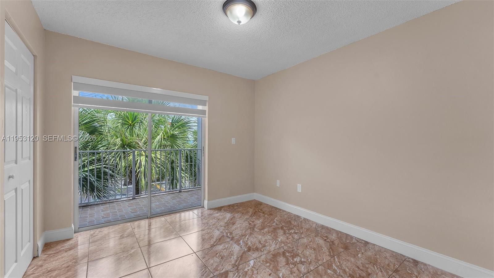 2780 West 76th Street, Unit 203 Hialeah, FL 33016 - Photo 18 of 21 a view of an empty room with wooden floor and a window