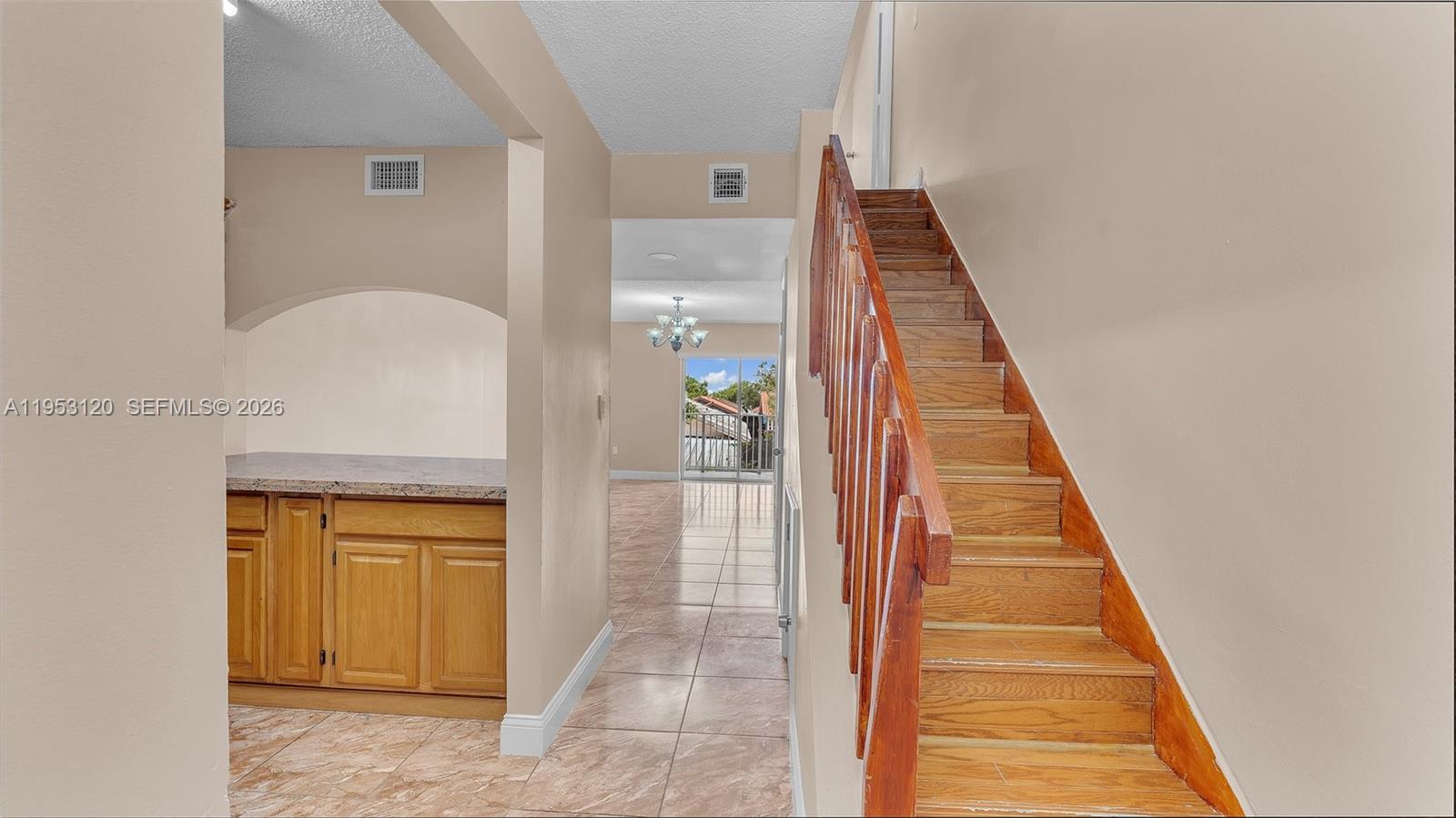 2780 West 76th Street, Unit 203 Hialeah, FL 33016 - Photo 5 of 21 a view of a hallway with wooden floor and staircase