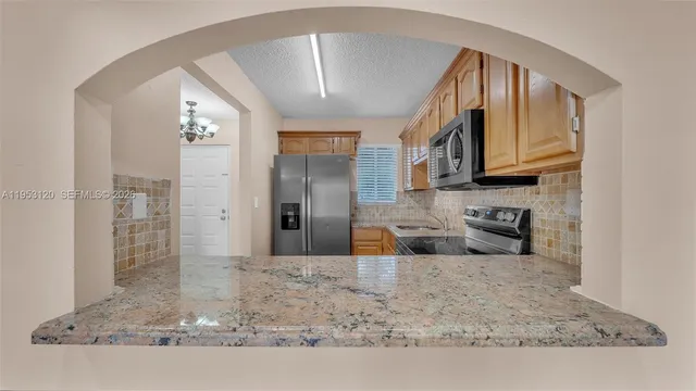 a view of a kitchen with granite countertop a sink