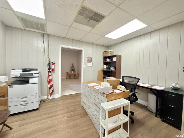 a backyard of a house with lots of trees and furniture