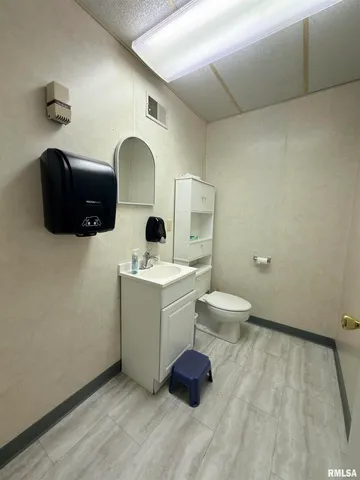 a view of house with yard and trees in the background