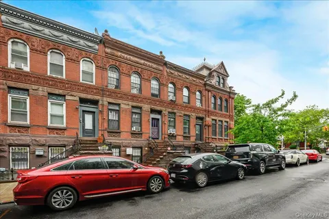 a couple of cars parked in front of a building