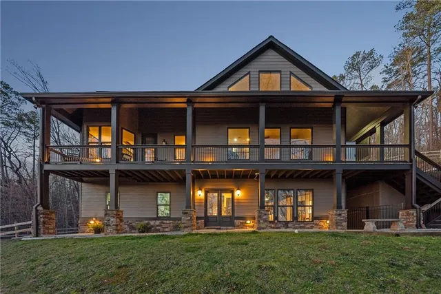 a front view of a house with a yard and trees