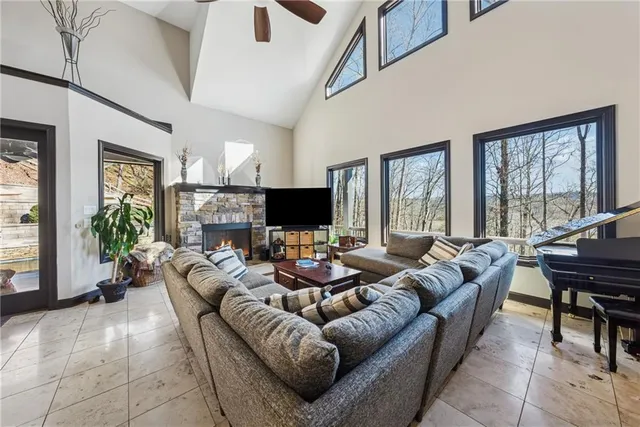 a dining area with stainless steel appliances kitchen island granite countertop a dining table chairs and a oven