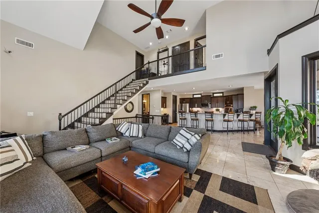 a large kitchen with stainless steel appliances granite countertop a refrigerator stove microwave and sink