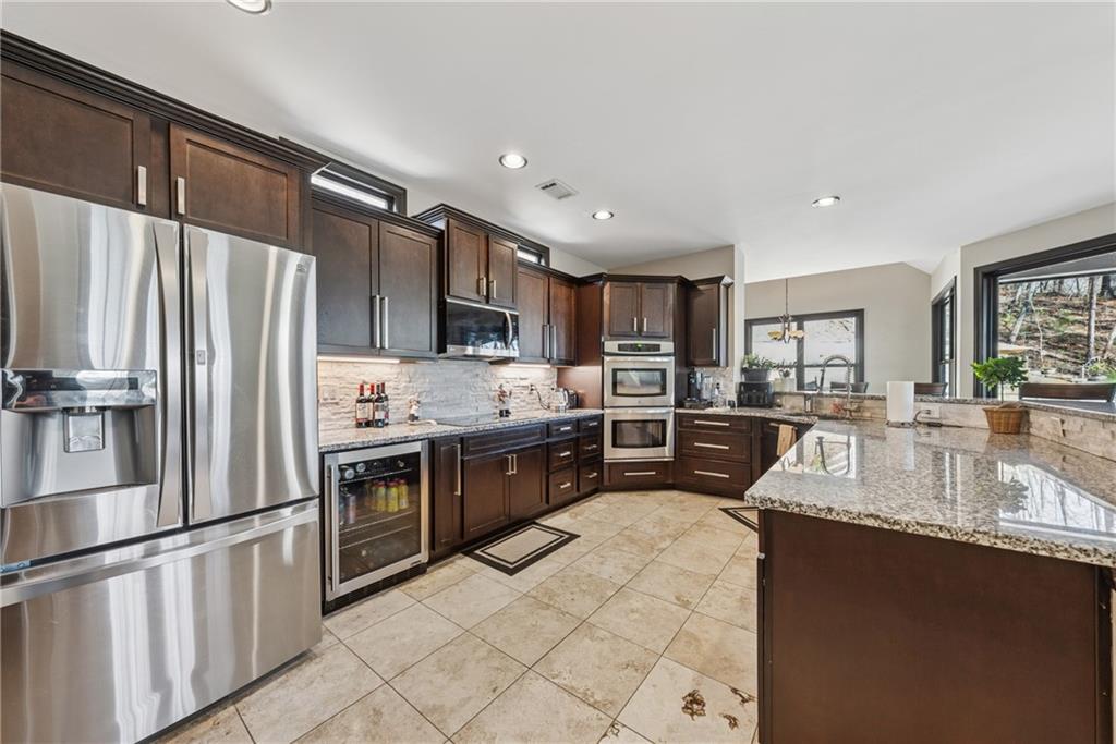 101 Bevil Ridge Road Southeast Emerson, GA 30137 - Photo 15 of 74 a large kitchen with stainless steel appliances granite countertop a refrigerator stove microwave and sink