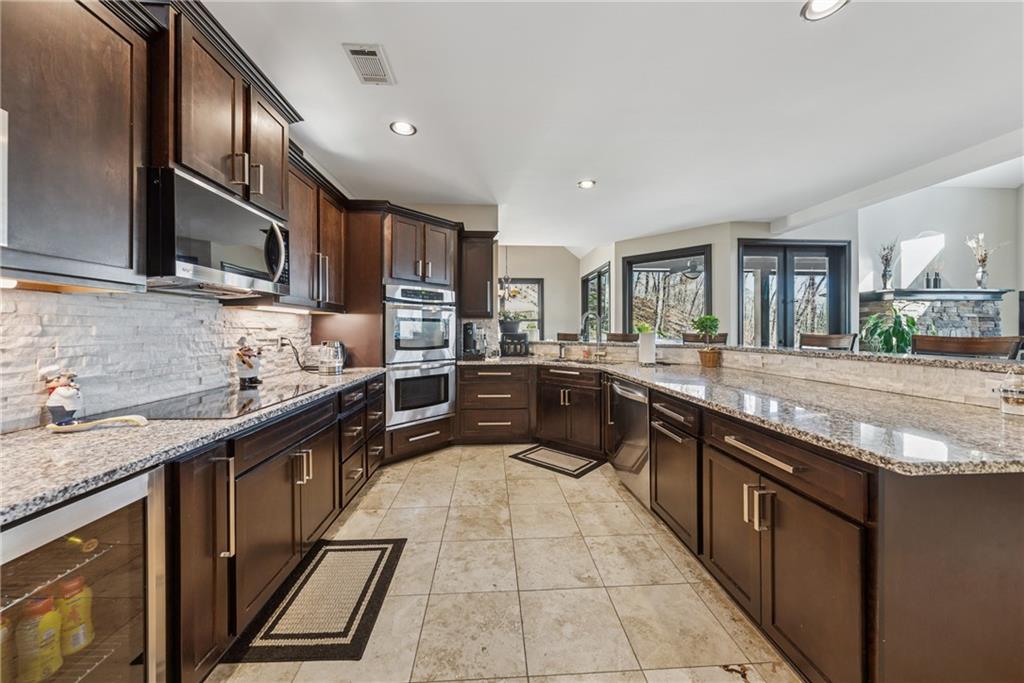 101 Bevil Ridge Road Southeast Emerson, GA 30137 - Photo 16 of 74 a kitchen with stainless steel appliances granite countertop a sink and stove