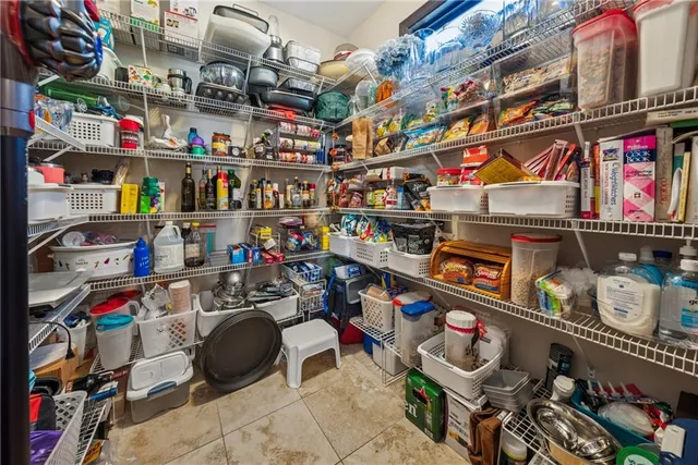 a large bathroom with a granite countertop double vanity sink a mirror and a bathtub