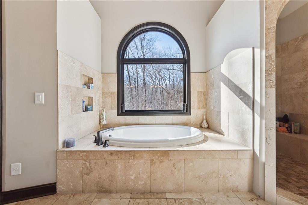 101 Bevil Ridge Road Southeast Emerson, GA 30137 - Photo 26 of 74 a bath tub sitting in a bathroom next to a window