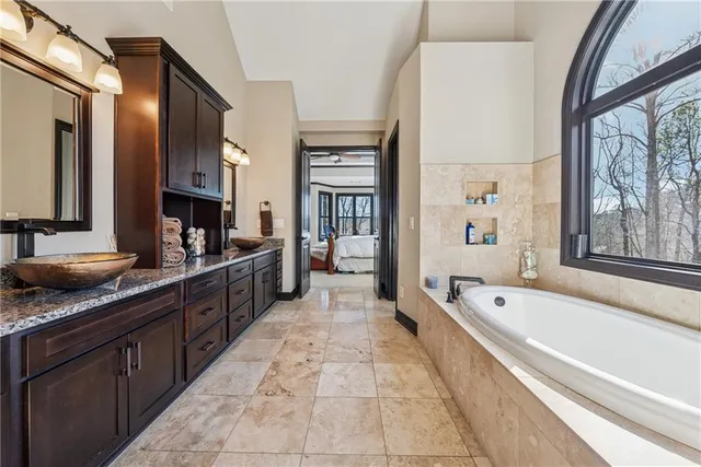 a bedroom with a large bed and a chandelier