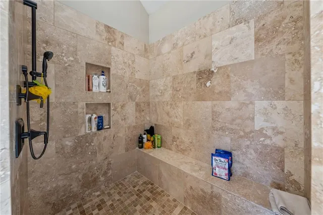 a bathroom with a double vanity sink toilet and mirror