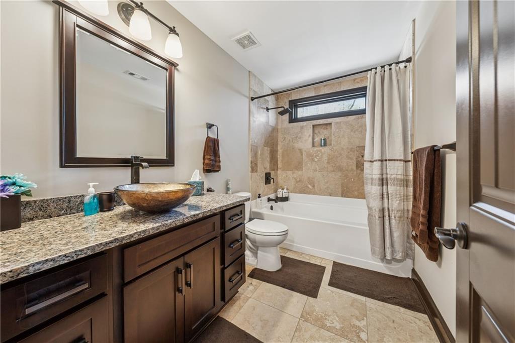 101 Bevil Ridge Road Southeast Emerson, GA 30137 - Photo 34 of 74 a bathroom with a granite countertop sink mirror bathtub and toilet