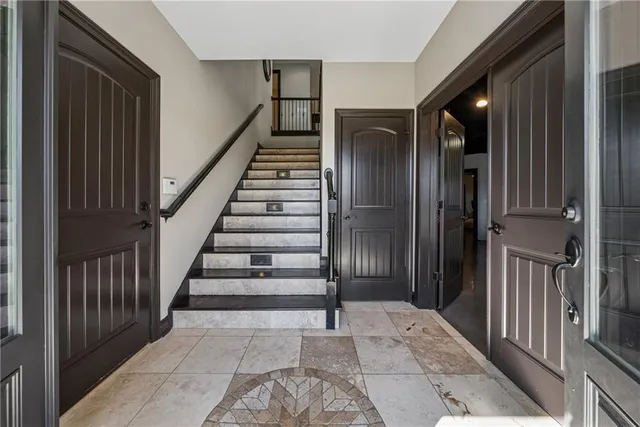 a view of a patio with a table and chairs under an umbrella