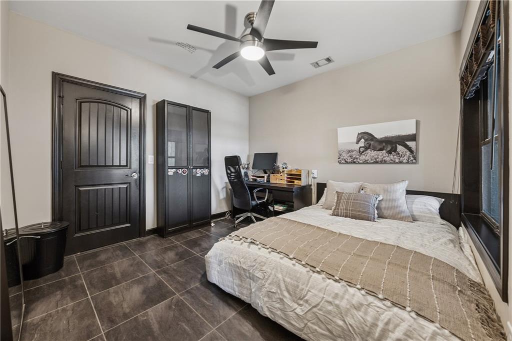 101 Bevil Ridge Road Southeast Emerson, GA 30137 - Photo 39 of 74 a bedroom with a large bed and a chandelier