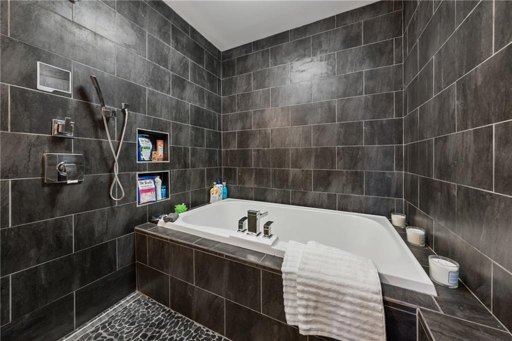 101 Bevil Ridge Road Southeast Emerson, GA 30137 - Photo 41 of 74 a bathroom with a bathtub a sink and a shower