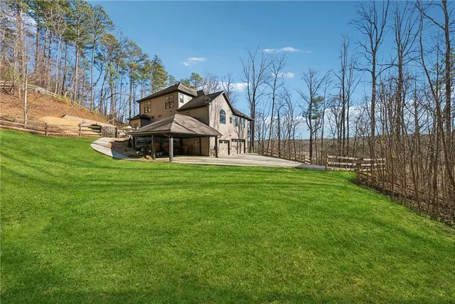 a living room with furniture fireplace and a large window