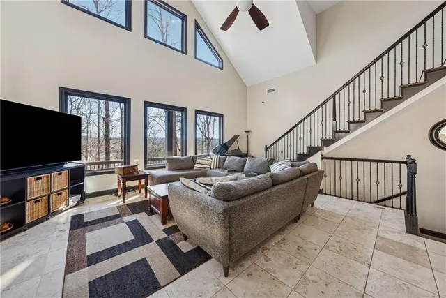 a kitchen with stainless steel appliances kitchen island granite countertop a refrigerator a stove a sink a dining table and chairs