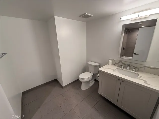 a kitchen with granite countertop a stove and a sink