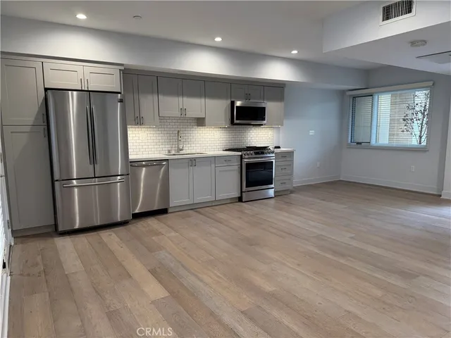 a kitchen with granite countertop a stove and a sink
