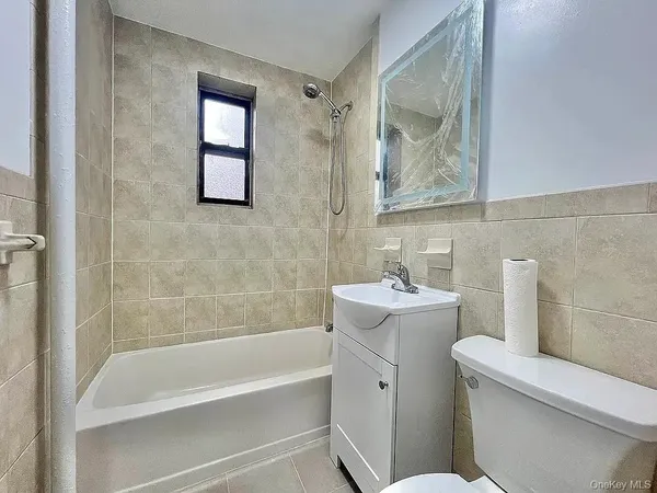 a bathroom with a sink mirror bathtub and toilet
