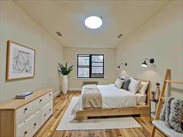 a bedroom with a bed and a dresser