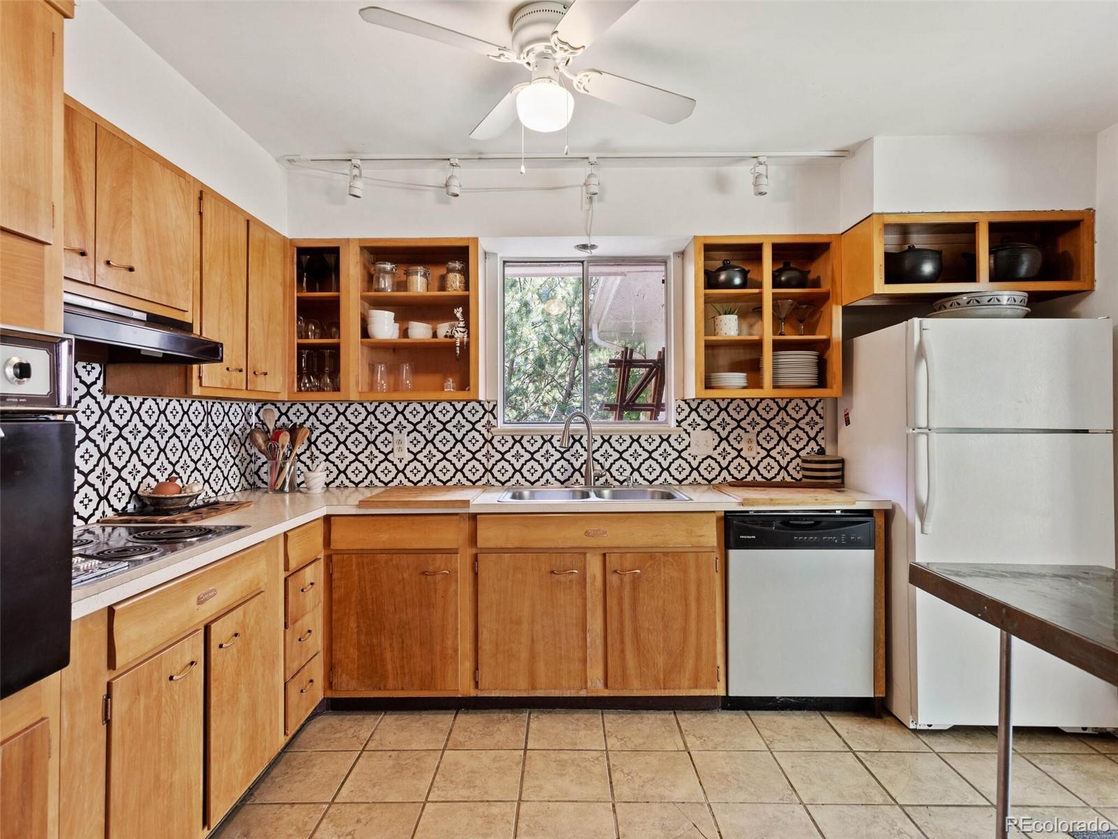 547 South Williams Street Denver, CO 80209 - Photo 11 of 18 a kitchen with stainless steel appliances granite countertop a sink and a refrigerator