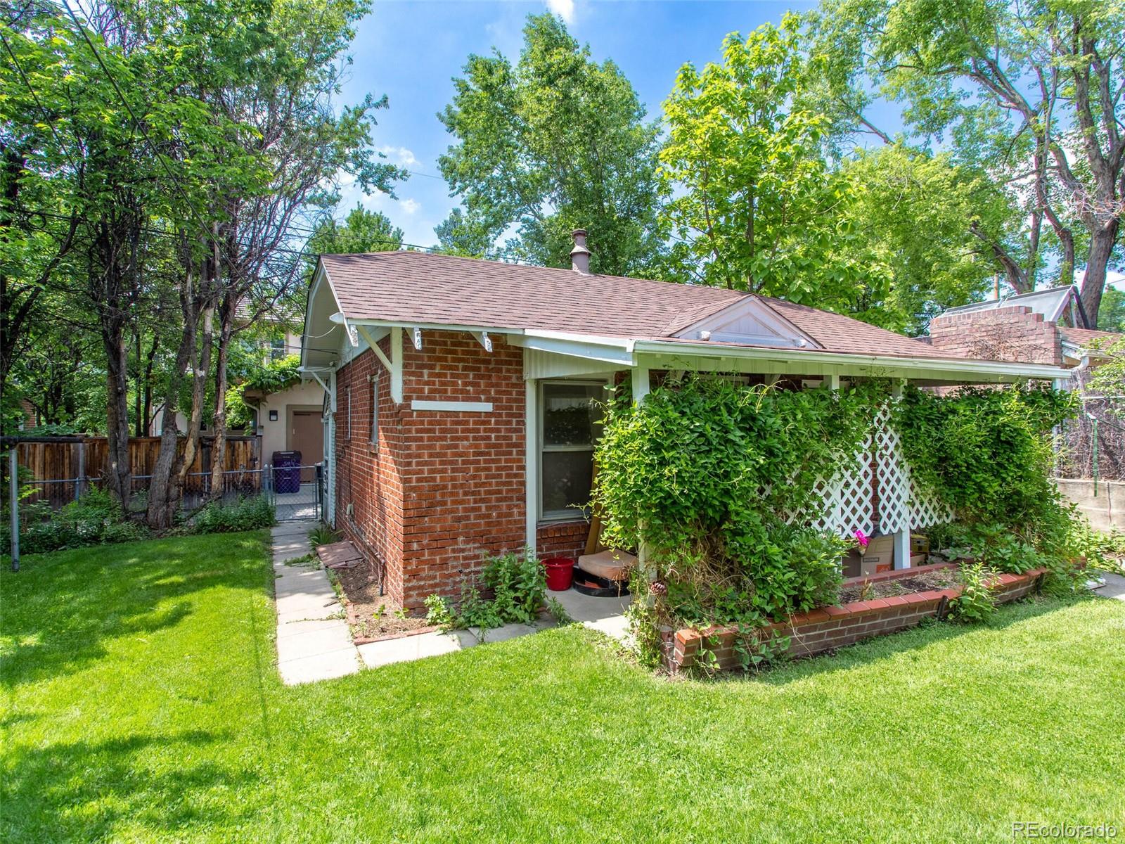 547 South Williams Street Denver, CO 80209 - Photo 5 of 18 a front view of a house with a yard
