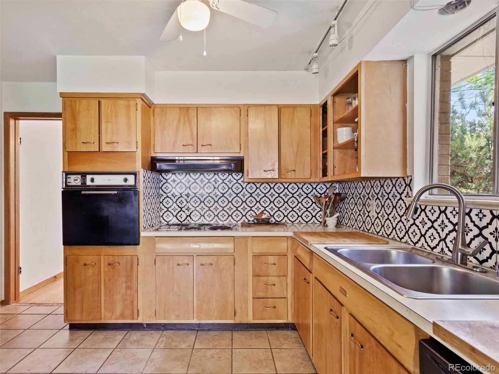 547 South Williams Street Denver, CO 80209 - Photo 10 of 18 a kitchen with a sink stove and cabinets