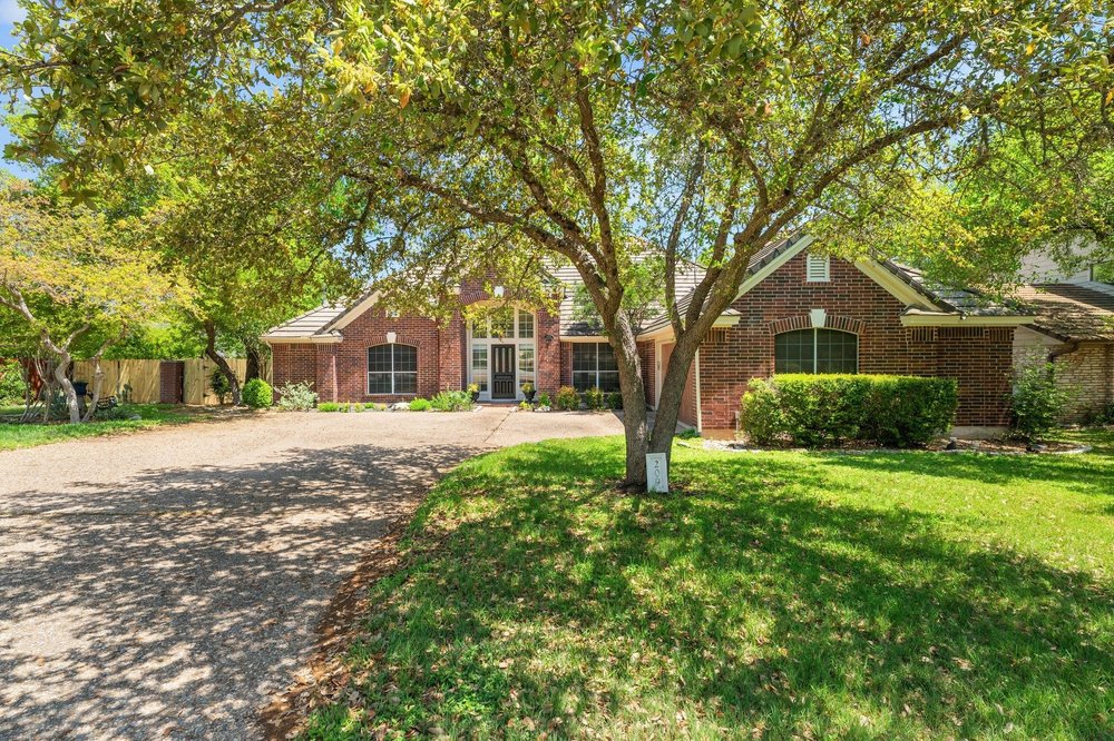 209 El Rio Drive Lakeway, TX 78734 - Photo 1 of 40 a front view of house with yard and green space