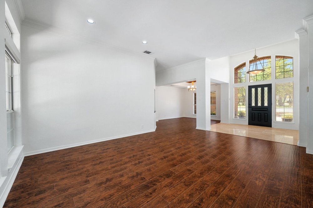 209 El Rio Drive Lakeway, TX 78734 - Photo 11 of 40 a view of empty room with wooden floor and fan