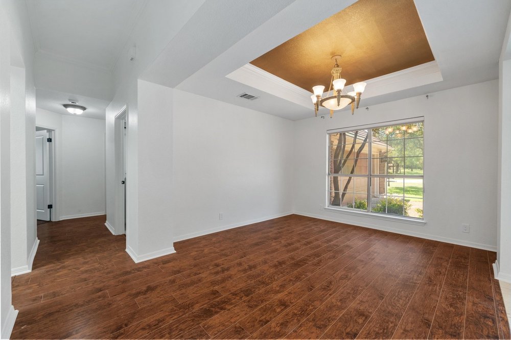 209 El Rio Drive Lakeway, TX 78734 - Photo 12 of 40 wooden floor in an empty room with a window