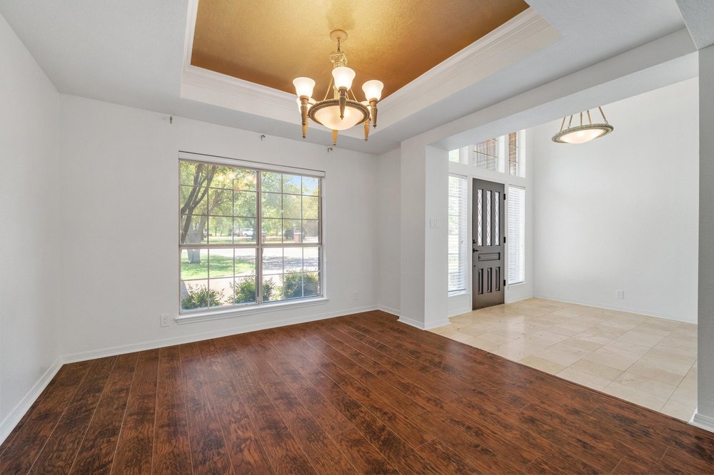 209 El Rio Drive Lakeway, TX 78734 - Photo 13 of 40 wooden floor in an empty room with a window