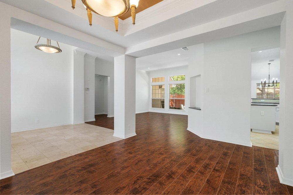209 El Rio Drive Lakeway, TX 78734 - Photo 14 of 40 a view of an empty room with wooden floor and a window