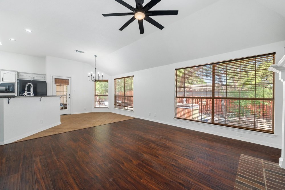 209 El Rio Drive Lakeway, TX 78734 - Photo 20 of 40 a view of an empty room with window and wooden floor