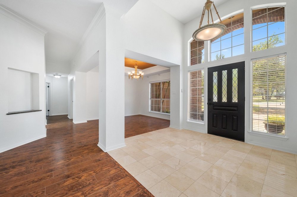209 El Rio Drive Lakeway, TX 78734 - Photo 2 of 40 a view of empty room with wooden floor and windows