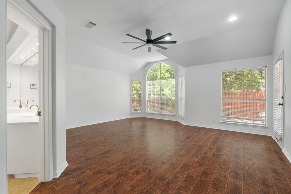 209 El Rio Drive Lakeway, TX 78734 - Photo 21 of 40 wooden floor in an empty room with a window