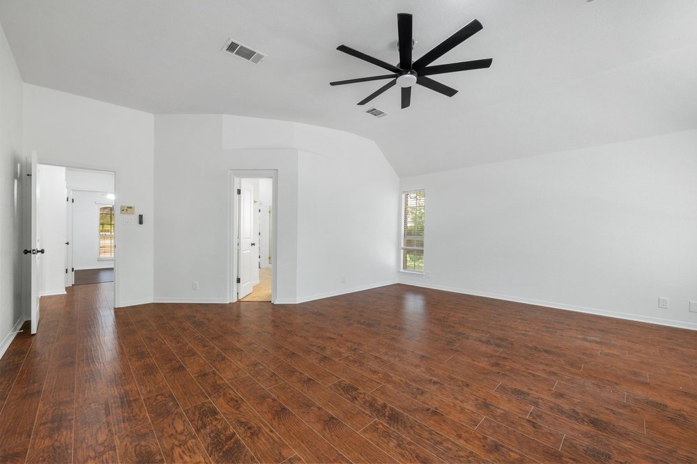209 El Rio Drive Lakeway, TX 78734 - Photo 23 of 40 wooden floor in an empty room with a window