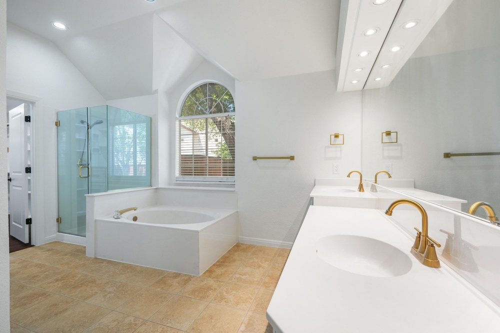 209 El Rio Drive Lakeway, TX 78734 - Photo 24 of 40 a bath tub sitting in a bathroom next to a sink