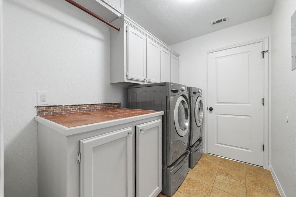 209 El Rio Drive Lakeway, TX 78734 - Photo 30 of 40 a utility room with dryer and washer