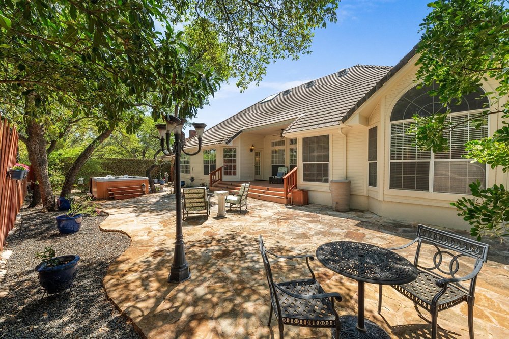 209 El Rio Drive Lakeway, TX 78734 - Photo 32 of 40 a view of a house with backyard and sitting area