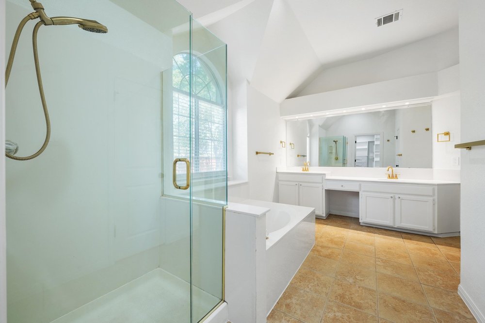 209 El Rio Drive Lakeway, TX 78734 - Photo 4 of 40 a bathroom with a tub sink and mirror
