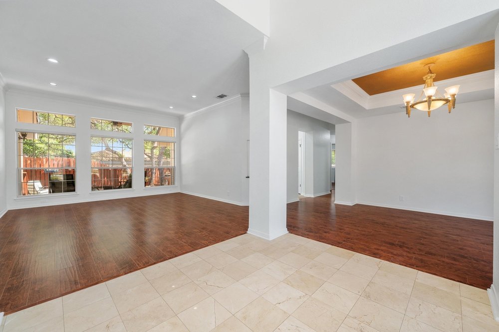209 El Rio Drive Lakeway, TX 78734 - Photo 8 of 40 a view of a livingroom with wooden floor and a large window