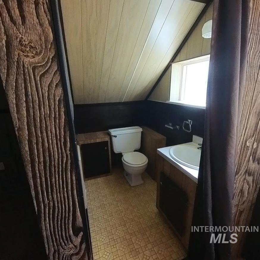 418 13th Street Clarkston, WA 99403 - Photo 8 of 26 Half bath featuring vanity, vaulted ceiling, wooden ceiling, and light flooring