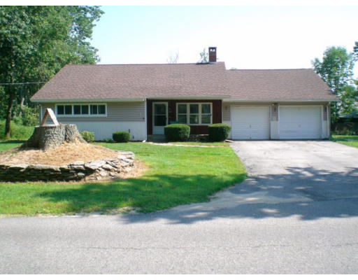 108 S Road Templeton, MA 01468 - Photo 1 of 18 a front view of a house with a yard and garage