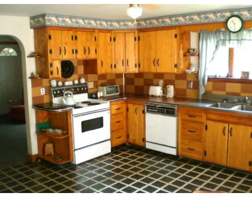 108 S Road Templeton, MA 01468 - Photo 5 of 18 a kitchen with stainless steel appliances a stove and white cabinets