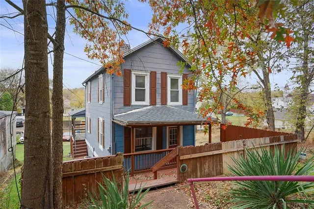 a front view of a house with a yard and potted plants