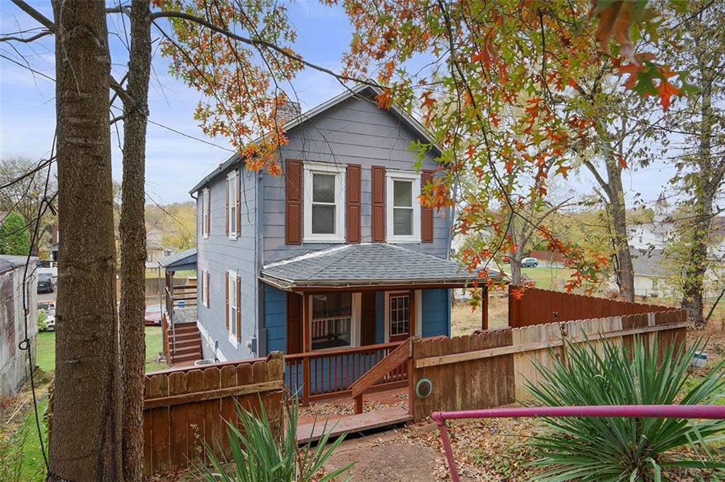 4111 Wildcat Road New Kensington, PA 15068 - Photo 1 of 48 a front view of a house with a yard and potted plants