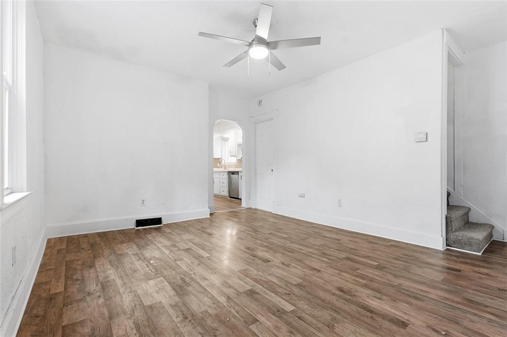 4111 Wildcat Road New Kensington, PA 15068 - Photo 11 of 48 an empty room with wooden floor and fan