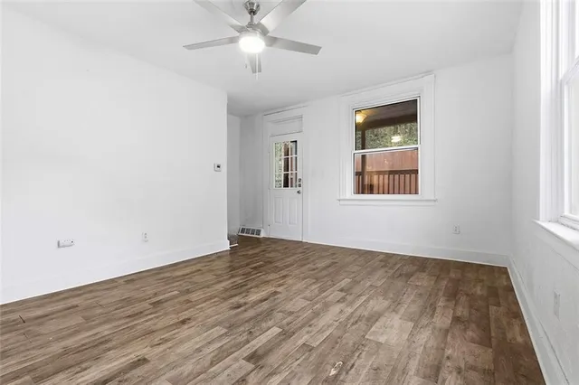 wooden floor in an empty room with a window
