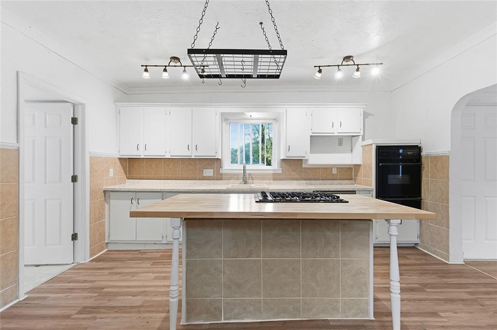 4111 Wildcat Road New Kensington, PA 15068 - Photo 14 of 48 a kitchen with kitchen island granite countertop a sink cabinets a refrigerator and a stove